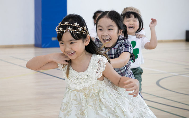 Wellington College Bangkok Children playing on international day in traditional dress