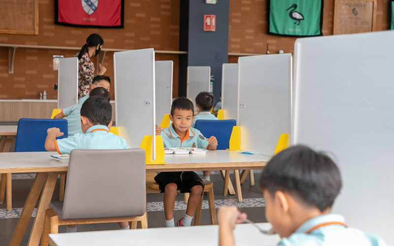 Children socially distanced in dining hall